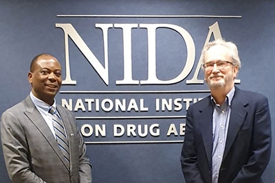 Dr. Martin Agwogie, left, and Dr. Steve Gust at NIDA headquarters.
