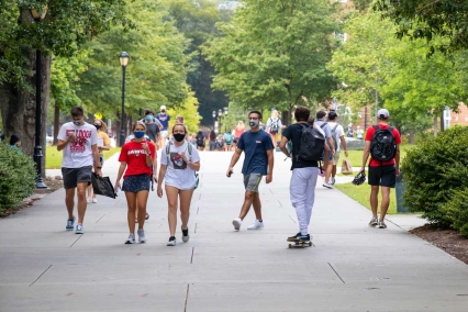 Young adults walking around a college campus