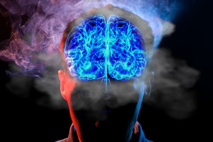 A blue lit up brain with smoke around it.