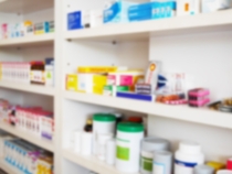 Pharmacy store with blurred medicines arranged on shelves